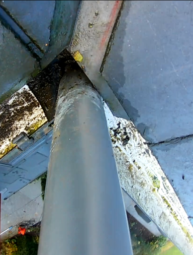 A view from our inspection camera, gutter vacuum system removing dirt and debris from a gutter.  
